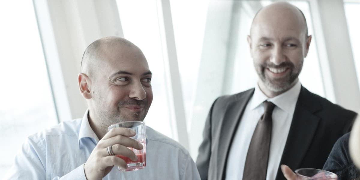 A group of colleagues stand inside DFDS ferry during a business cruise