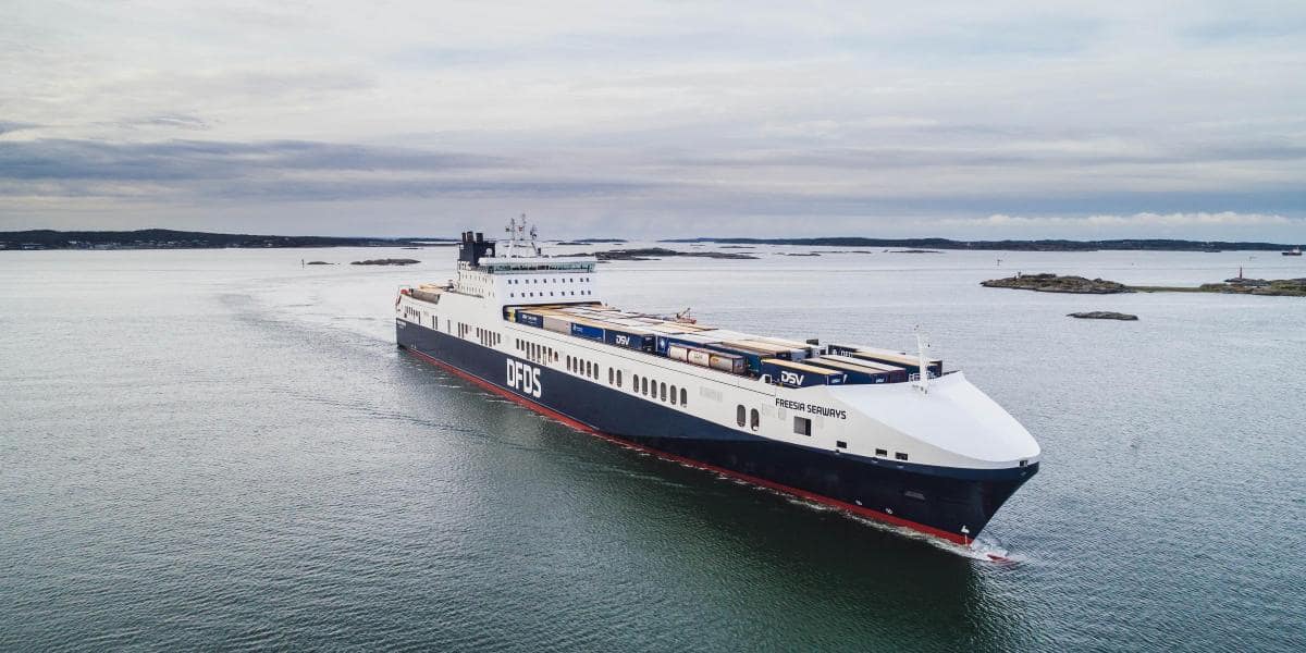 DFDS vessel Freesia Seaways, sailing on the open sea, carrying a full load of unaccompanied trailers