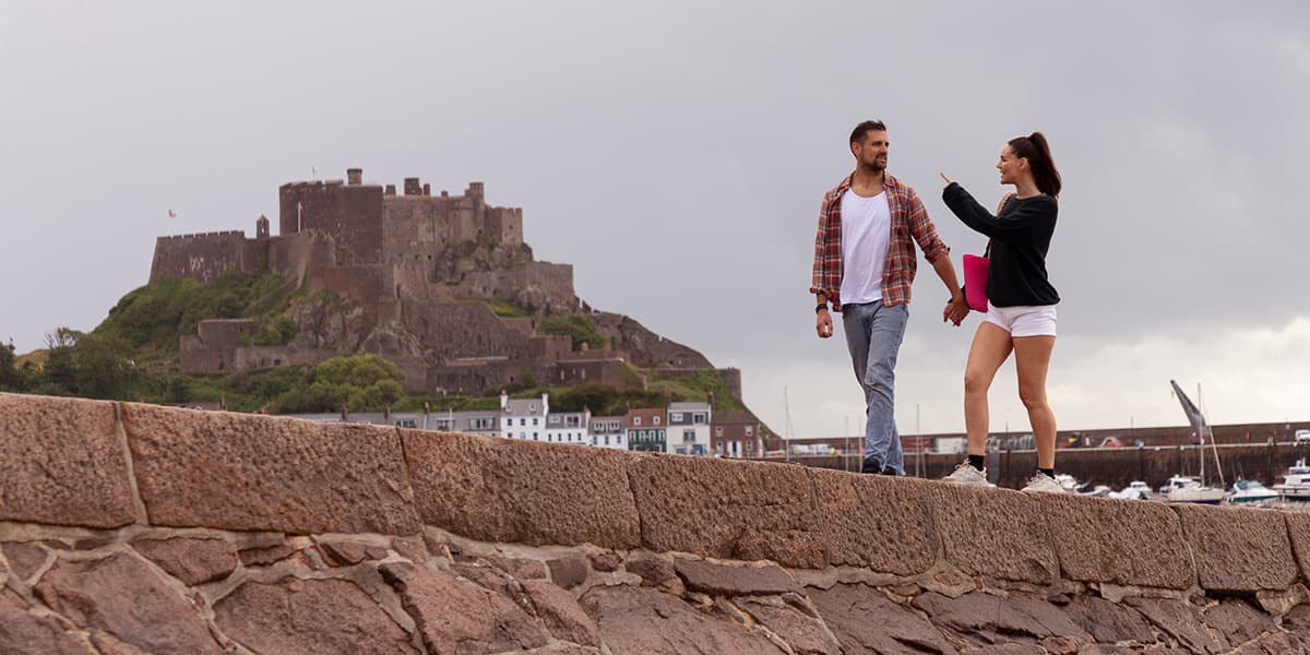 Couple looking at Mont Orgueil Castle, Jersey