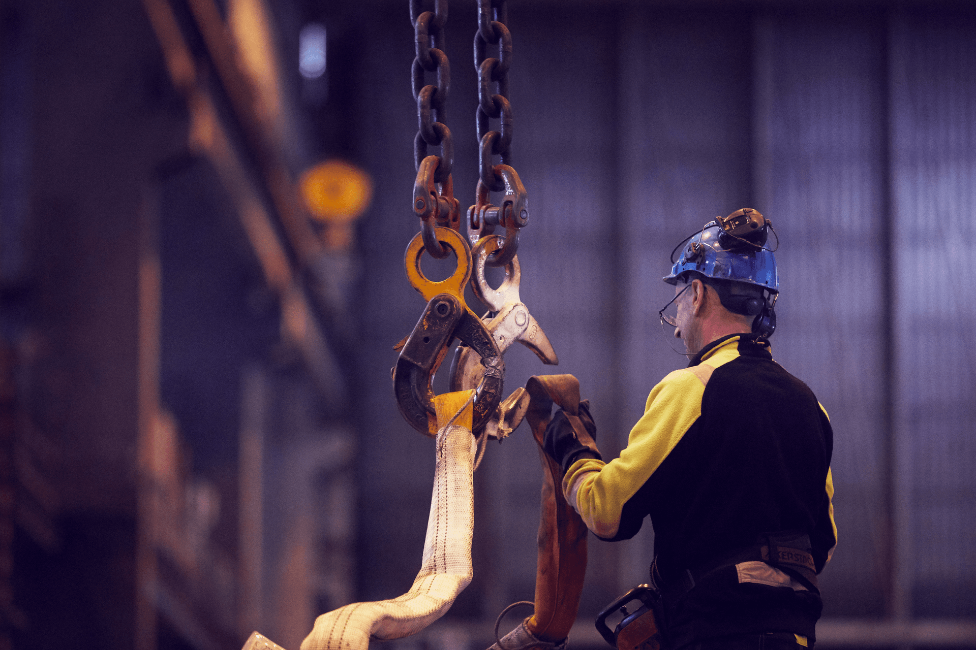 A man working hard with steel elements at the warehouse in Gothenburg