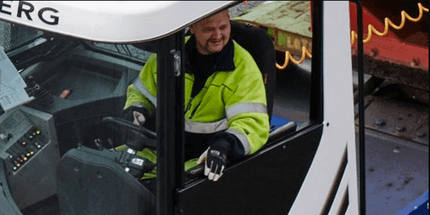 DFDS employee driving a loader in a shipyard