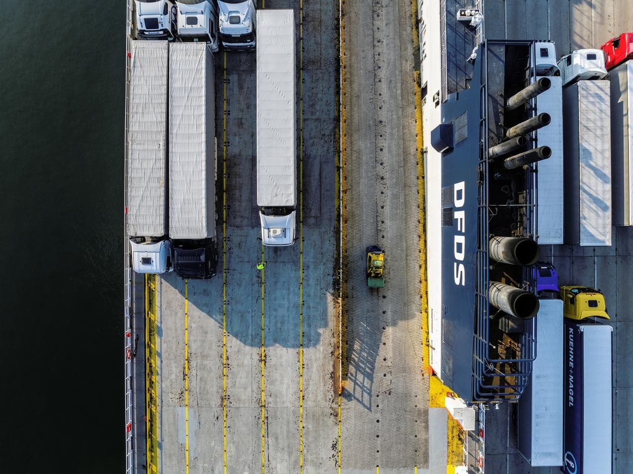 A DFDS freight ship at port with cargo.