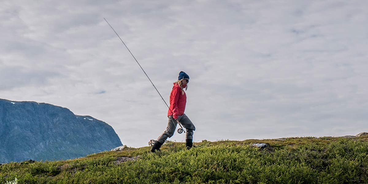 Image of fisherwoman walking with fishing rod