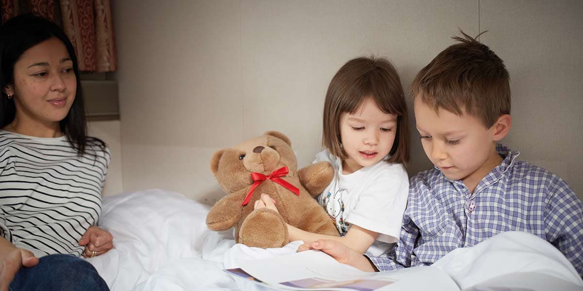 Family relaxing in DFDS inside cabin