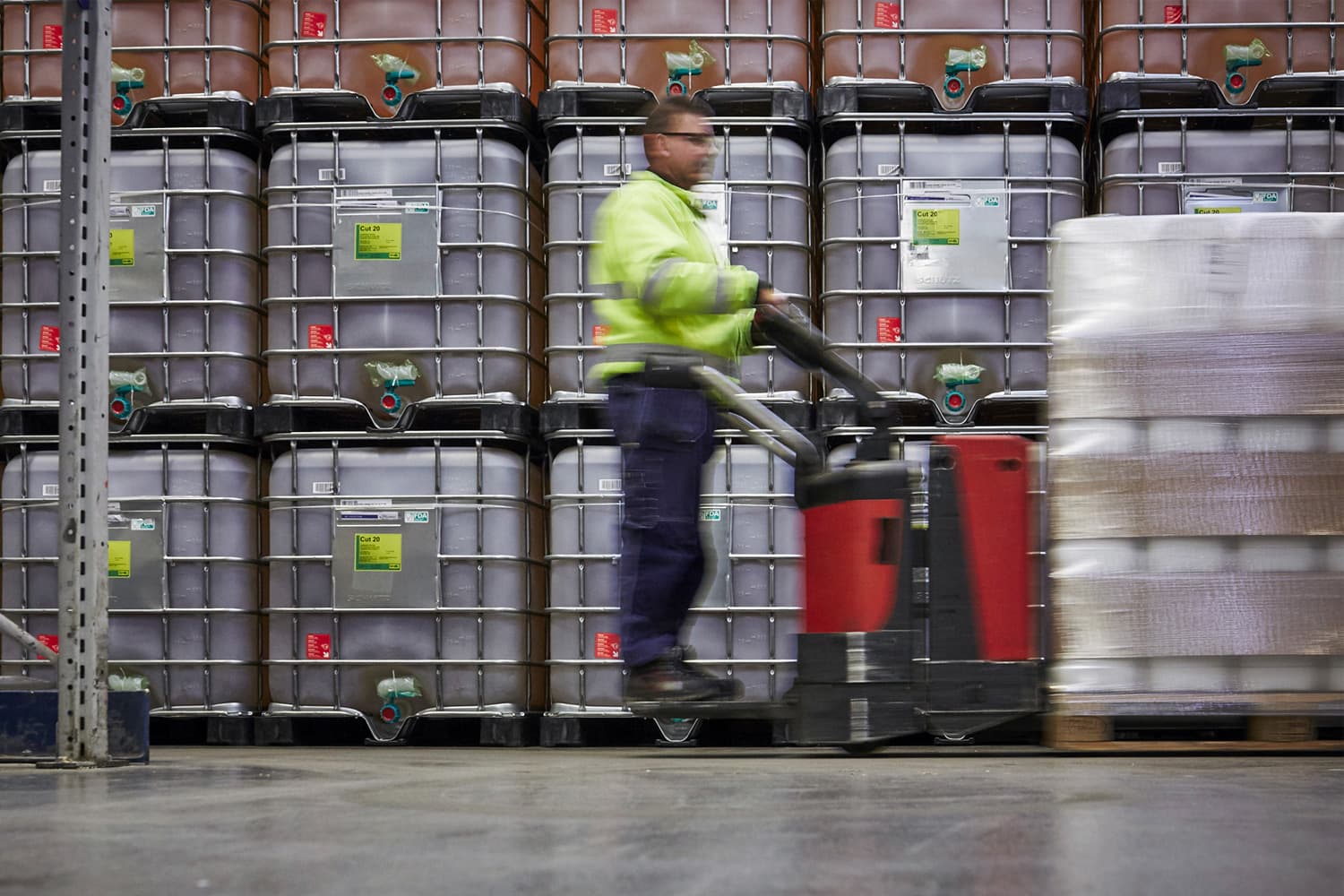 A DFDS Logistics employee moving chemicals inside a warehouse