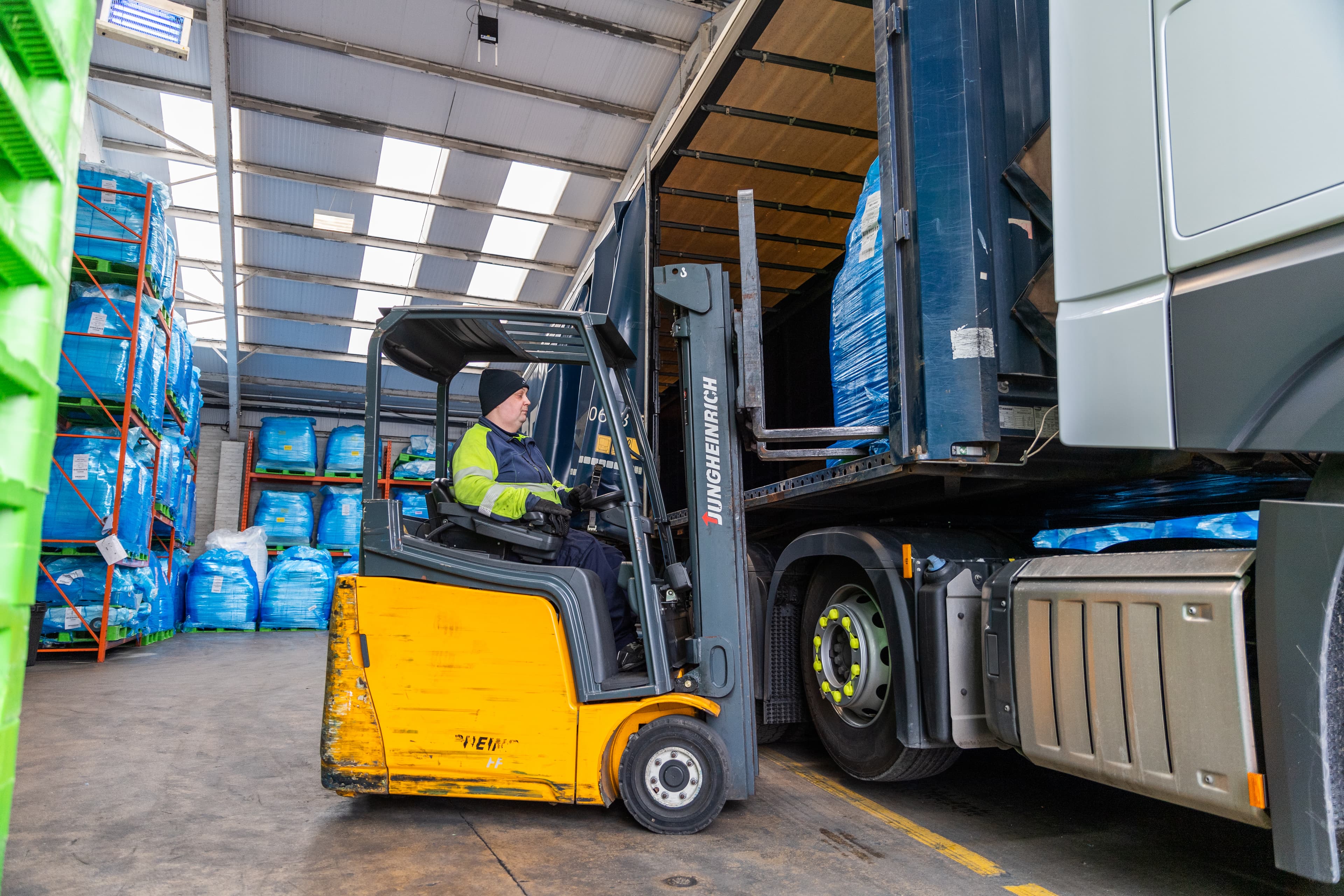 Cold chain 2022, worker loading truck with forklift