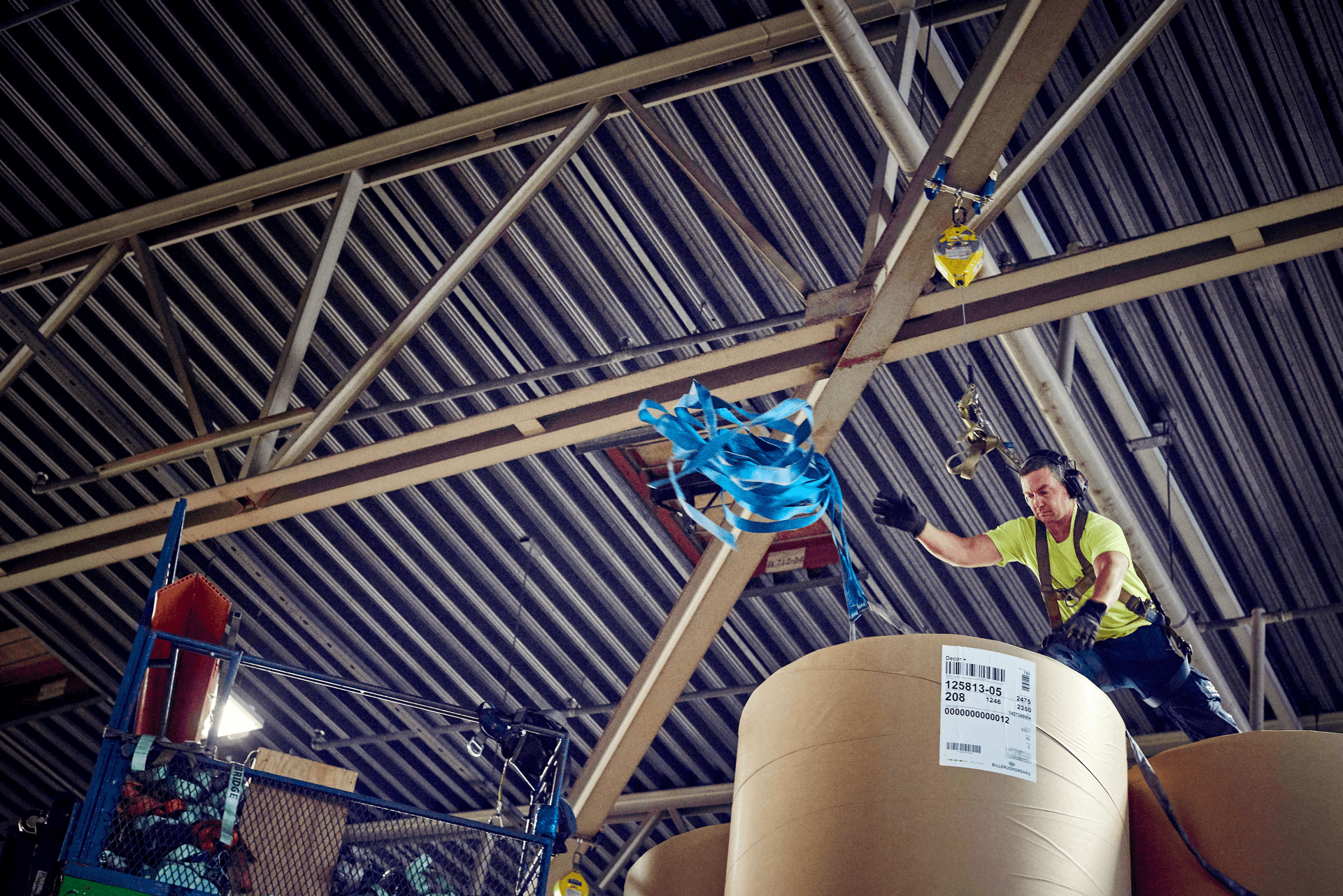 A DFDS employee tosses rope over products in a warehouse