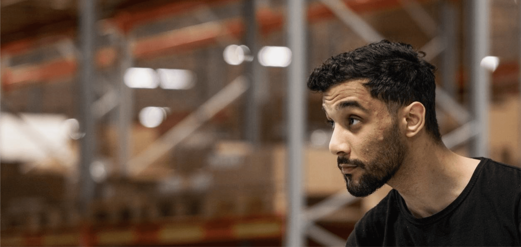 Male DFDS worker inside a warehouse, looking forward precisely