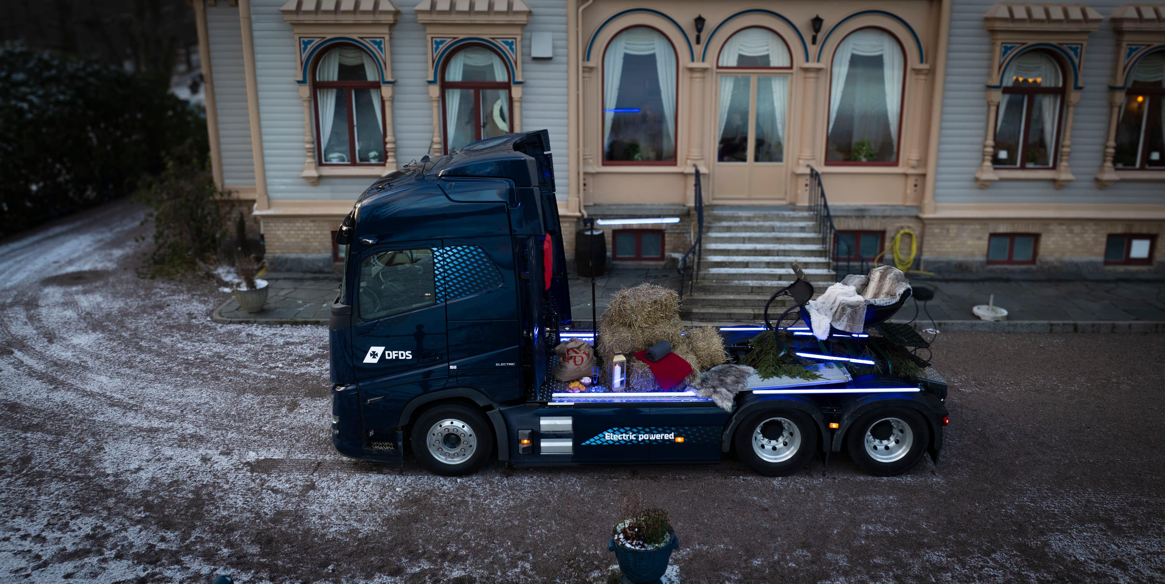 DFDS electric truck with holiday sleigh on it.