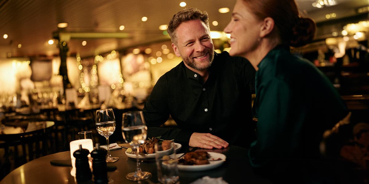 A couple making a toast with their glass of wine