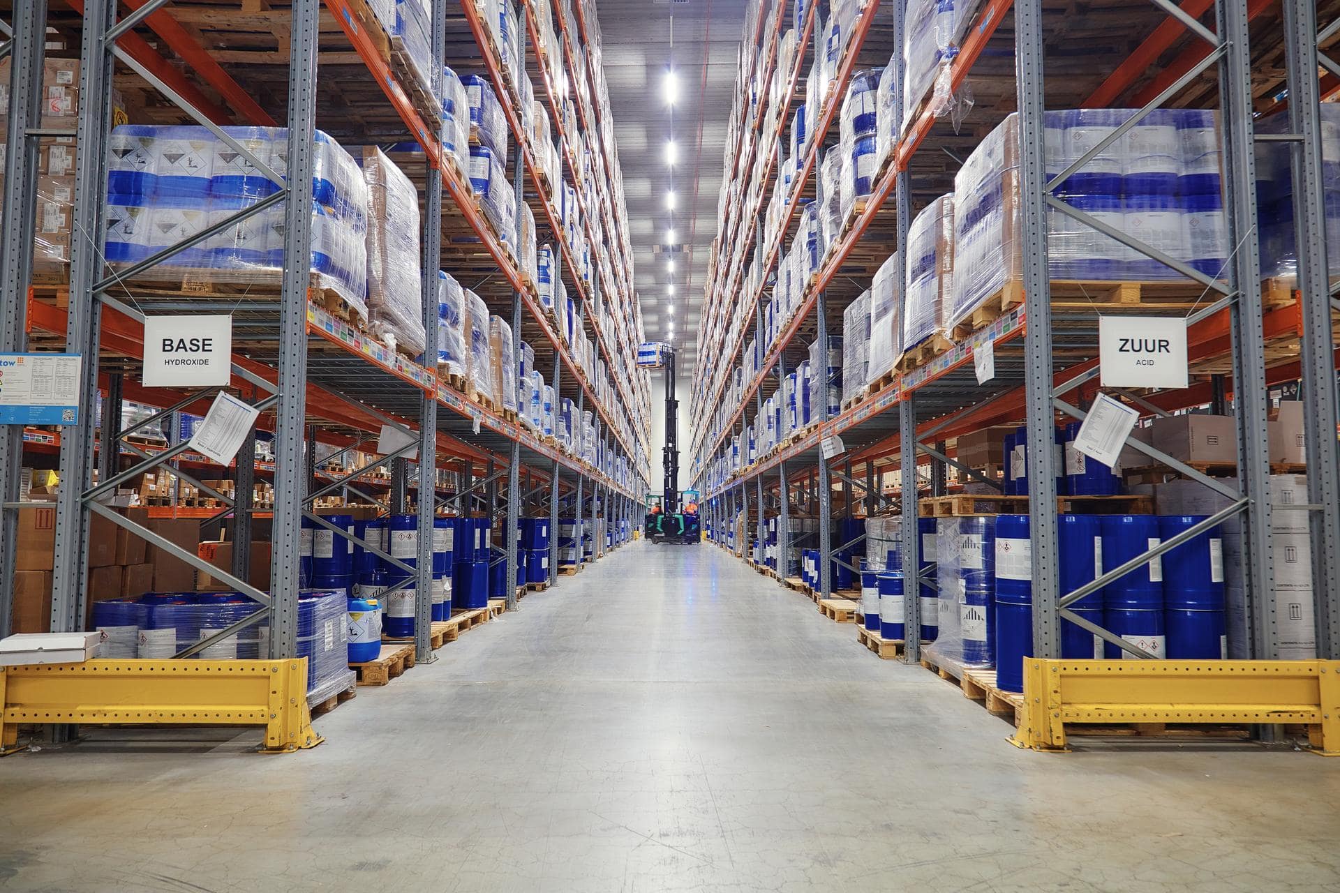 Interior of a warehouse with pallets stacked.