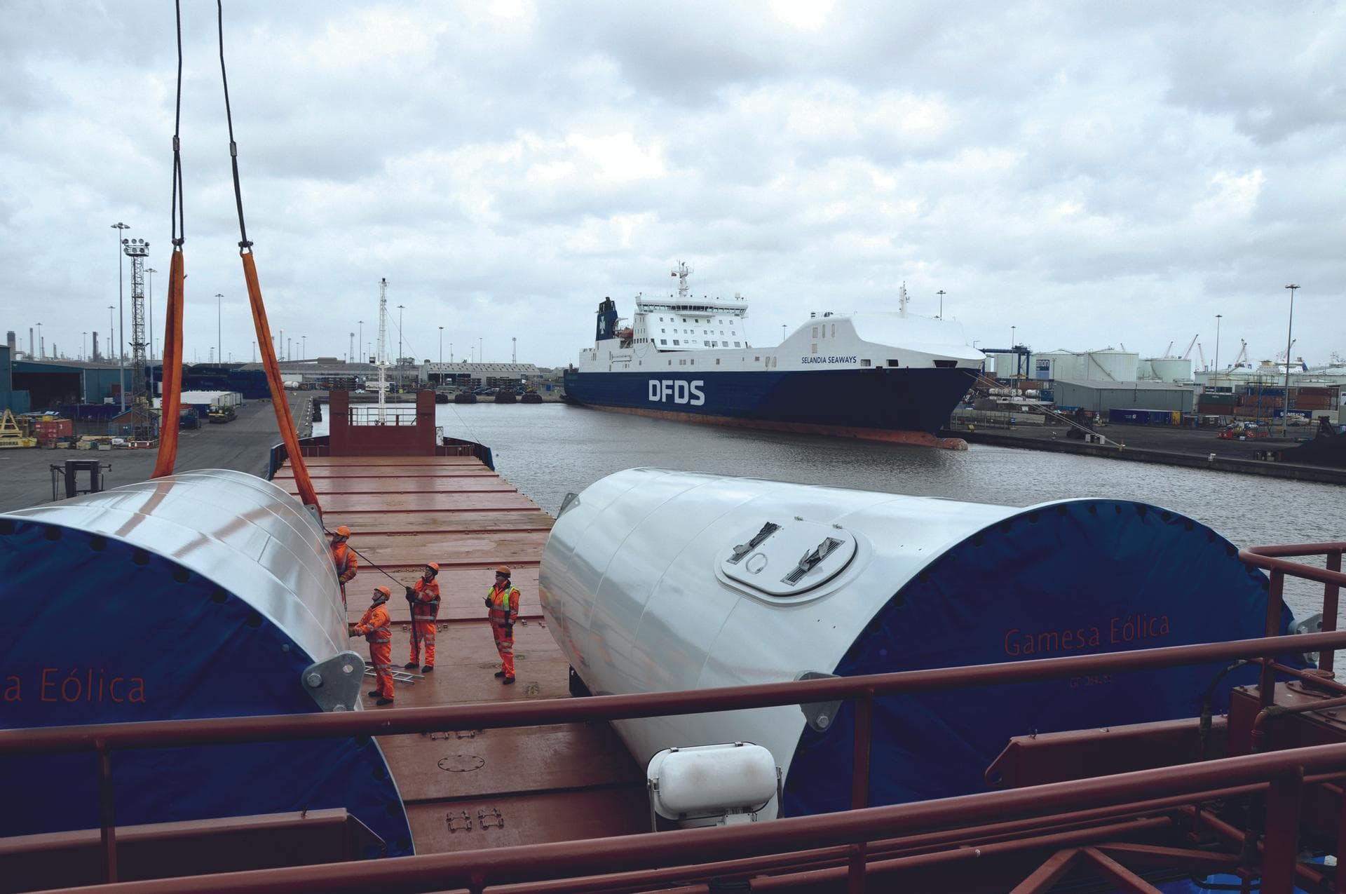 Four men preparing a special cargo turbine load on a vessel