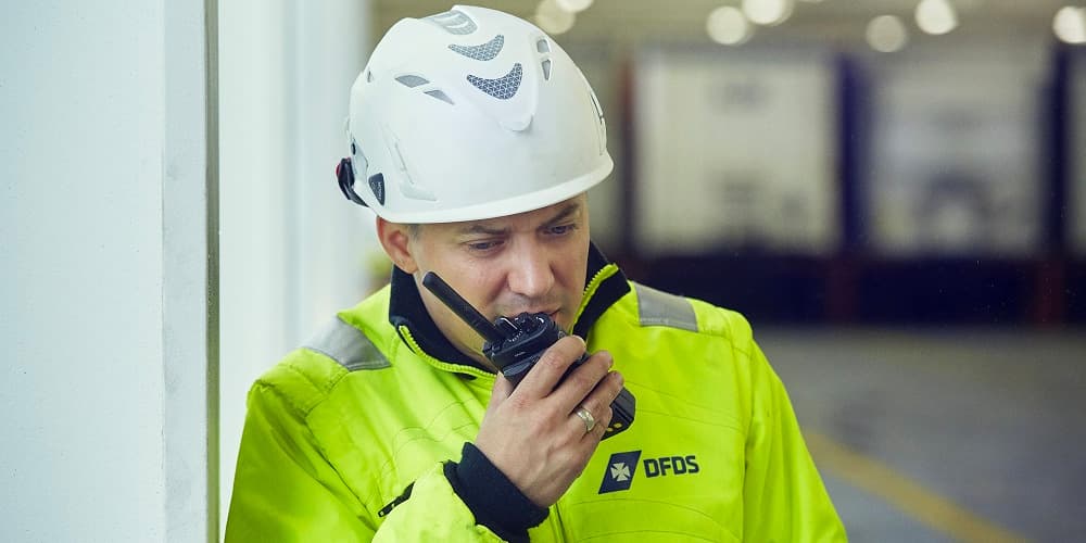DFDS employee speaking into a radio