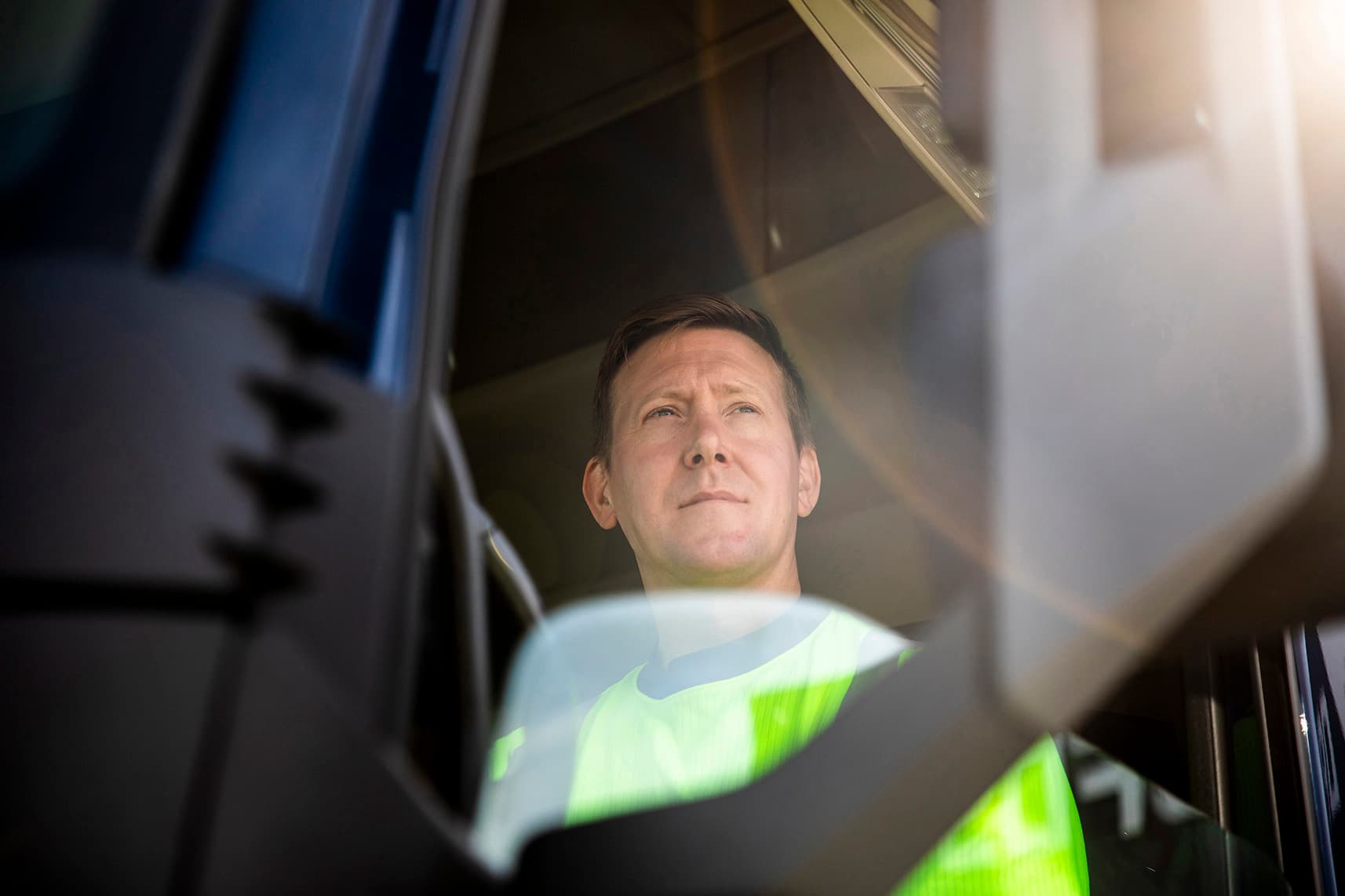 Driver driving, high vis shirt, daytime