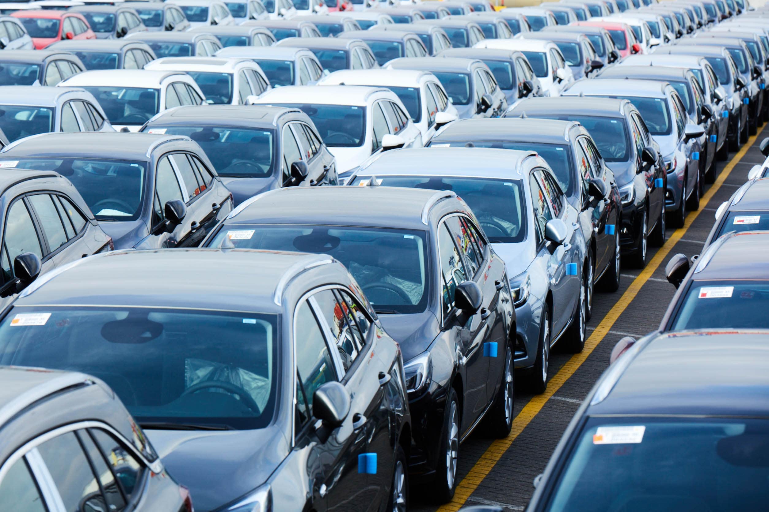 New cars lined up to enter a DFDS Freight Shipping terminal for transportation