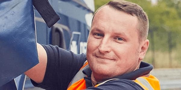 DFDS employee tying down a soft-side trailer