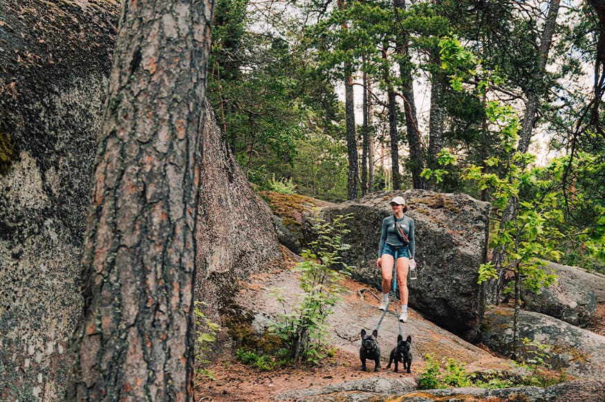Woman with couple dogs in the forest