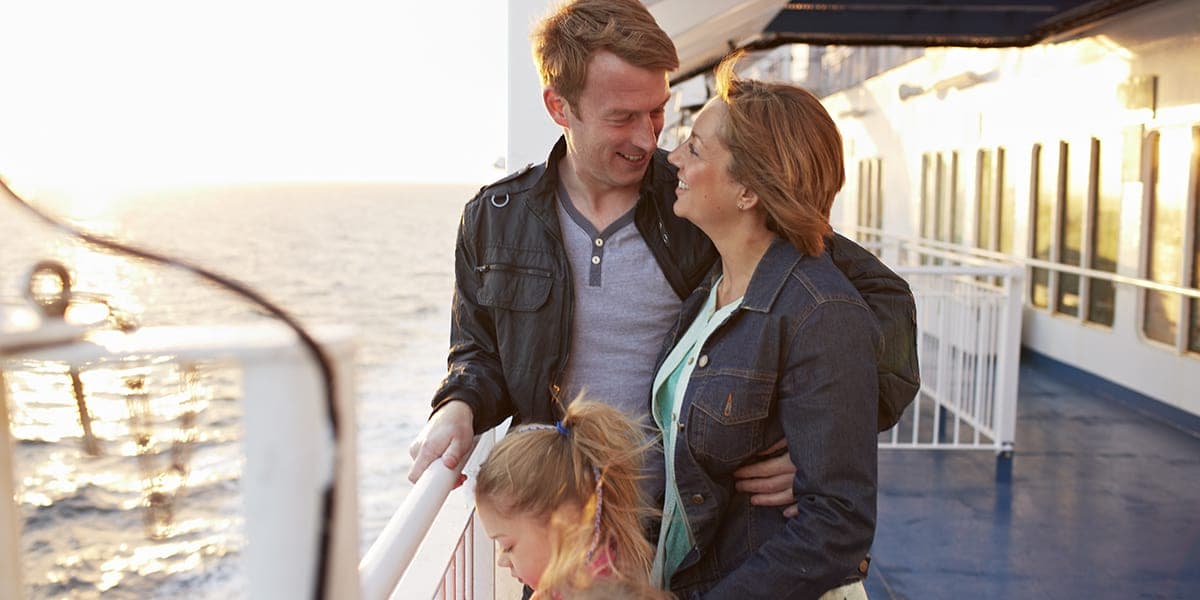 Young family on the deck of a DFDS ferry at sunset